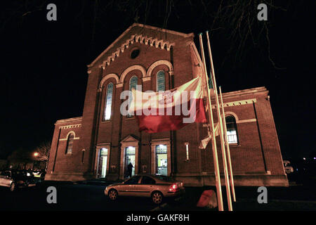 Eine polnische Flagge fliegt auf halber Mast vor einer Gedenkfeier für die ermordeten polnischen Männer Mariusz Szwajkos und Pawel Kalita in der Kirche der Guten Jungfrau Maria in Dublin. Stockfoto