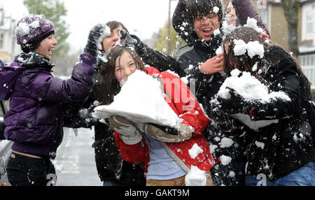 Jugendliche haben heute eine Schneeballschlacht in Chiswick, West London. Stockfoto