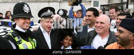 Der neu gewählte Londoner Bürgermeister Boris Johnson trägt einen Polizist-Hut auf dem Trafalgar Square im Zentrum von London während der Sikh New Year Festival-Feierlichkeiten von Vaisakhi. Stockfoto