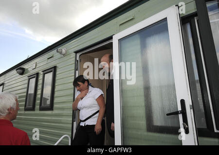 Hochwasserminister John Healey (rechts) traf auf dem Caravanplatz in toll Bar bei Doncaster auf Bewohner, die noch in Wohnwagen leben, während ihre Häuser nach den Überschwemmungen des letzten Jahres repariert wurden. Stockfoto