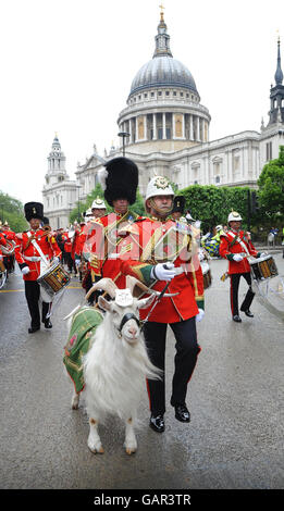 Shenkin, eine ziege aus der Herde der Königin und das Maskottchen der Territorialarmee, mit Handler David Joseph während einer Parade anlässlich des 100. Jahrestages der TA, die von St. Paul's Cathedral nach einem Gedenkgottsdienst in die Guildhall, London ging. Stockfoto