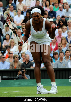 Die US-Amerikanerin Serena Williams reagiert in ihrem Spiel gegen die französische Amelie Mauresmo während der Wimbledon Championships 2008 im All England Tennis Club in Wimbledon. Stockfoto