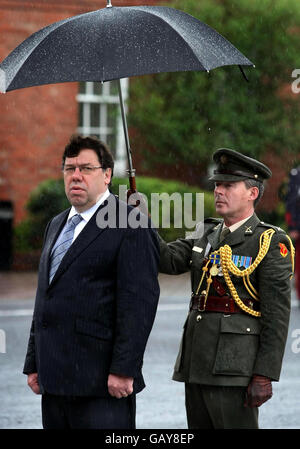 Taoiseach Brian Cowen wird heute bei einer Parade anlässlich der 50 Jahre Friedenssicherung der Verteidigungskräfte in den McKee Barracks, Dublin, von seiner Aide De Comp , Mick Treacy, geschützt. Stockfoto