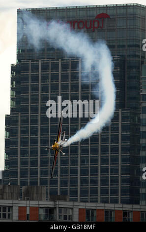 Der US-Amerikaner Kirby Chambliss fliegt vor dem Citigroup-Gebäude in Canary Wharf, als er am Qualifying für die Londoner Etappe der Red Bull Air Race World Series über der Themse teilnimmt. Stockfoto