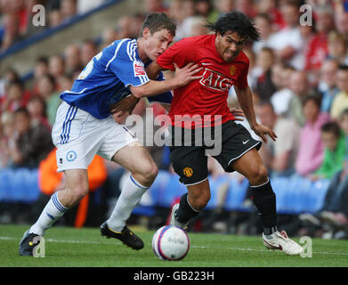 Carlos Tevez (rechts) von Manchester United kämpft während des Vorsaison-Freunds in der London Road, Peterborough, um den Ball mit Paul Coutts von Peterborough United. Stockfoto