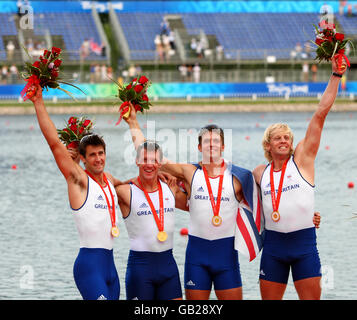 Die Ruderer Großbritanniens (von links), Tom James, Steve Williams, Pete Reed und Andrew Triggs Hodge, singen die Nationalhymne, nachdem sie während der Olympischen Spiele 2008 in Peking in China im Vierer-Finale der Männer im Shunyi Olympic Ruder-Kanusport-Park Gold gewonnen hatten. Stockfoto