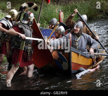 Enthusiasten des National Living History Festival am Lankark Loch in Schottland reinszenieren eine Szene aus der Geschichte als Wikinger-Raider in einem Langschiff-Kampf mit römischen Soldaten. Stockfoto