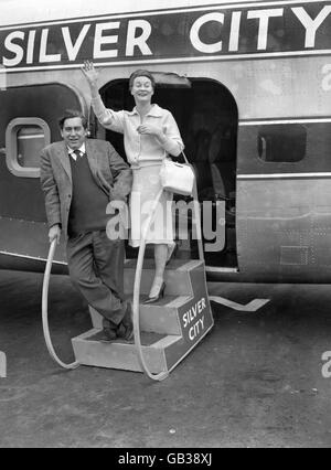 Der Radiokomiker Tony Hancock und seine Frau Cecily stiegen heute auf dem Weg nach Cannes für das Filmfestival in ein Flugzeug am Flughafen Lydd ein. Sie werden auch Orte für den Film besuchen, an dem Herr Hancock im nächsten Monat arbeiten wird. Stockfoto