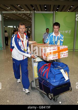 Olympische Spiele - Olympische Spiele In Peking 2008. Ein Mitglied des britischen Ruderteams wird vor den Olympischen Spielen 2008 in Peking, China, durch den Flughafen von Peking unterstützt. Stockfoto