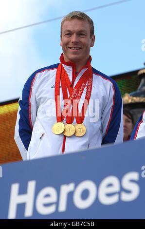 Der dreifache Goldmedaillengewinner Chris Hoy zeigt seine Medaillen auf Der Festwagen während der Team GB Homecoming Parade in Im Zentrum Von London Stockfoto