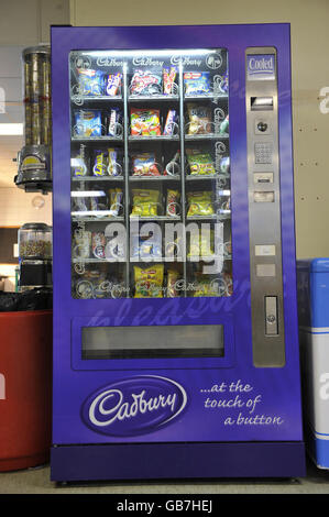 Ein ungesunder Automaten mit zuckerhaltigen Süßigkeiten, Schokolade und Chips in einem walisischen Krankenhaus. Stockfoto