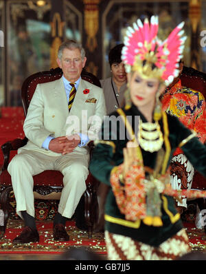 Der Prinz von Wales sitzt mit seiner Exzellenz Sri Sultan Hamengkubuwono X (verdeckt), während sie einen traditionellen Tanz beobachten, bei dem zwei Prinzessinnen um die Liebe eines Königs wetteifern, im Kraton Palace, Yogyakarta Indonesiens alter ehemaliger königlicher Hauptstadt. Stockfoto