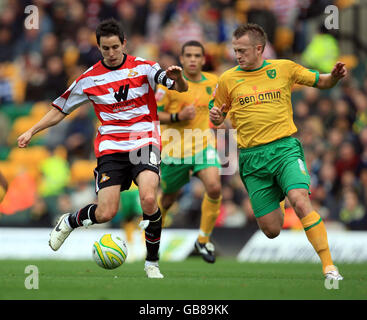 Sammy Clingans von Norwich City und Brian Stock von Doncaster Rovers kämpfen während des Coca-Cola Championship-Spiels in der Carrow Road, Norwich, um den Ball. Stockfoto