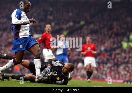 Manchester United Torhüter Tim Howard rettet vor den Füßen „Dwight Yorke“ Von Blackburn Rovers Stockfoto