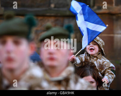 Der zweieinhalb Jahre alte Angel Brodie beobachtet die Heimreise der Argyll- und Sutherland-Highlander, die aus Afghanistan zurückgekehrt sind, während sie Stirling durchquert. Stockfoto