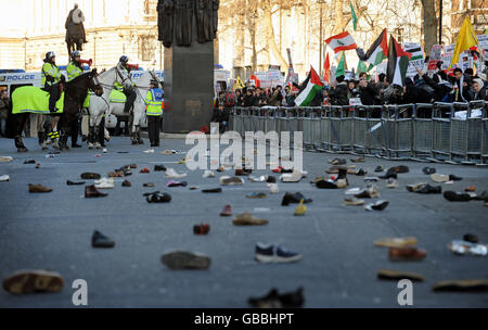 Hunderte von Schuhen liegen auf der Straße in Whitehall, nachdem Demonstranten versucht hatten, Schuhe in die Downing Street in London zu werfen. Die Demonstranten demonstrieren gegen die Bombardierung von Gaza und fordern ein sofortiges Ende der israelischen Angriffe. Stockfoto