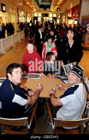 Nathan Hines (links unten) und Simon Webster (rechts unten) unterschreiben Autogramme während eines Rugby-Tages im Ocean Terminal, Edinburgh. Stockfoto