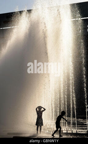 Kinder kühlen sich bei heißem Wetter in Almaty, Kasachstan, in Springbrunnen ab. Stockfoto