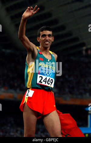 Leichtathletik - Olympische Spiele 2004 in Athen - 1500 m der Männer - Finale. Der Marokkaner Hicham El Guerrouj begrüßt die Menge, als er die Goldmedaille feiert Stockfoto