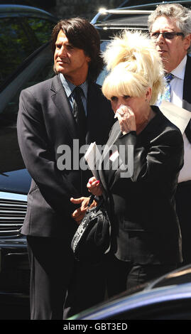 Barbara Windsor und Scott Mitchell (links) verlassen die Beerdigung von Danny La Rue in der Church of the Transfiguration in Kensal Rise, London. Stockfoto