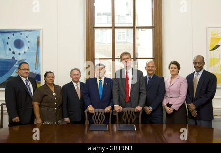 Stephen Timms MP (4. Rechts), der Finanzsekretär des Finanzministeriums, und W McKeeva Bush (4. Links), die Leiterin des Regierungsgeschäfts für die Cayman-Inseln, mit Mitgliedern der Cayman-Islands-Regierungsabteilung nach der Unterzeichnung eines Steuerabkommens im Finanzgebäude in Horseguards, London. Stockfoto