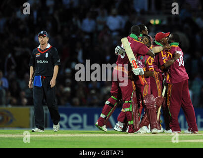 Der englische Kapitän Paul Collingwood (links) verlässt das Feld niedergeschlagen, während die Spieler von West Indies feiern, nachdem sie England beim ICC World Twenty20 Super Eights-Spiel beim Brit Oval in London besiegt haben. Stockfoto