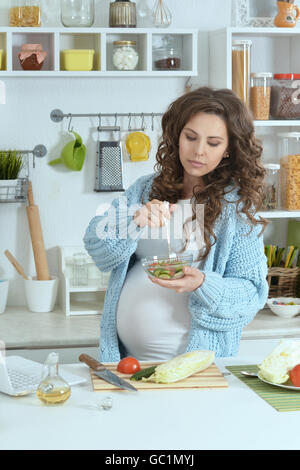 schöne schwangere Frau mit Nahrung Stockfoto