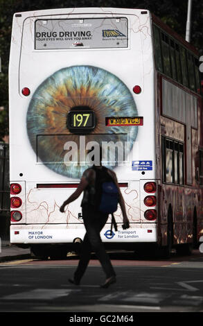 Eine Frau überquert die Straße hinter einem Bus, in dem das Plakat der neuen Drogenfahrkampagne von Transport for London in Croydon, London, gezeigt wird. Stockfoto