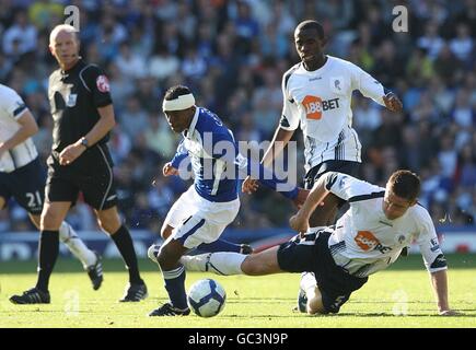 Cristian Benitez (links) von Birmingham City und Gary Cahill von Bolton Wanderers (Rechts) Kampf um den Ball als Schiedsrichter Steve Bennett (links) Sieht aus Stockfoto