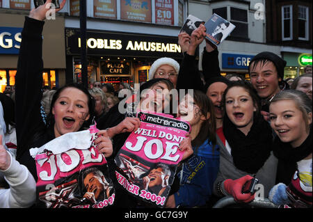 Fans warten draußen, als X-Factor-Sieger Joe McElderry CDs seiner Debüt-Single The Climb im HMV-Store auf der King Street in seiner Heimatstadt South Shields, South Tyneside, signiert. Stockfoto