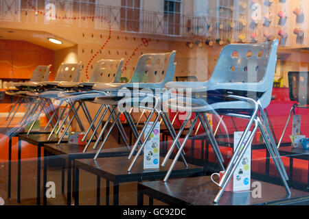 Stuhlreihen gestapelt auf den Tischen in einem Café-restaurant Stockfoto