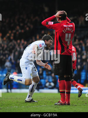 Robert Snodgrass von Leeds United (links) feiert sein Ausgleichstor in der Verletzungszeit, als Tommy Elphick von Brighton während des Coca-Cola League One Matches in der Elland Road, Leeds, niedergeschlagen steht. Stockfoto