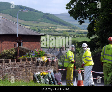 In Egremont werden Blumen-Tribute hinterlassen, während Arbeiter die Gegend säubern, nach dem Schussrausch von Derrick Bird in Cumbria, bei dem 12 Menschen ums Leben gekommen sind. Stockfoto