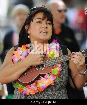 Maria Stonham aus Gloucester, beim Massenbusk im Stadtzentrum von Cheltenham während des ersten Ukulele-Festivals Großbritanniens, das dieses Wochenende in der Stadt stattfand. Stockfoto