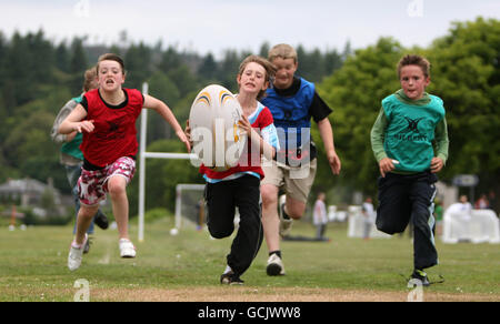 Kinder nehmen an Street Rugby on the Green in Lochgoilhead, Schottland, Teil. Stockfoto