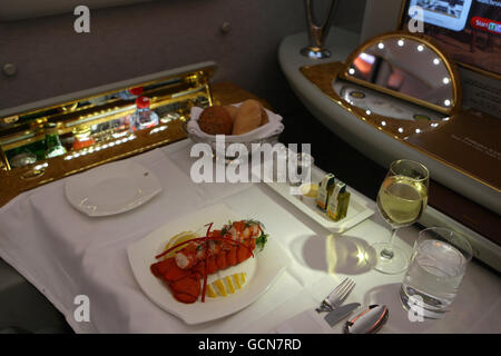 Eine Mahlzeit im First Class-Bereich eines Emirates Airbus A380 an dem Tag, an dem er zum ersten Mal am Flughafen Manchester landete, Manchester. DRÜCKEN Sie VERBANDSFOTO. Bilddatum: Mittwoch, 1. September 2010. Die in Dubai ansässige Fluggesellschaft Emirates flog das 500-Sitzer-Flugzeug zu Beginn ihrer täglichen Verbindungen zwischen Dubai und der nordenglischen Stadt nach Manchester. Emirates hat die A380, deren Flügel in Großbritannien hergestellt werden, nach Heathrow eingesetzt, aber dies ist das erste Mal, dass ein regionaler britischer Flughafen eine solche erhalten hat. Siehe PA Story AIR A380. Bildnachweis sollte lauten: Dave Thompson/PA Wire Stockfoto