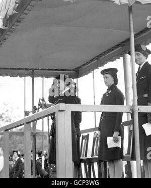 Mehr als 7000 Girl Guides aus London, die an einem Drumhead-Service teilnehmen und vorbeimarschieren. Prinzessin Elizabeth und Prinzessin Margaret waren dort, um am vergangenen marsch den Gruß zu nehmen. Der Trommelgottesdienst wurde vom Bischof von Willesden, der RT.Rev E.M.G. Jones. Bilderschau : Prinzessin Elizabeth beim Gruß an den vormarsch. Hinter ihr in der Uniform eines Sea Ranger steht Prinzessin Margaret. Mai 1946 Stockfoto