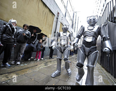 DR Who Fans werden von zwei Cybermen besucht, als sie sich vor HMV in der Oxford Street für eine Autogrammstunde für die neue DVD-Box des Programms anstellen, die von den Stars der Show, Matt Smith und Karen Gillan, gesetzt wird. Stockfoto