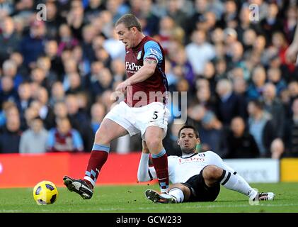 Fußball - Barclays Premier League - Fulham gegen Aston Villa - Craven Cottage. Richard Dunne von Aston Villa (links) und Clinton Dempsey von Fulham kämpfen um den Ball Stockfoto