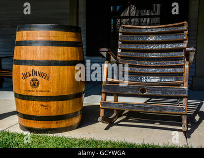 Schwarzes Holz Drehbank Stil Schaukelstuhl auf der Veranda an der Seite eine authentische Eiche Fass von Jack Daniels No 7 Whiskey, Lynchburg, Tennessee Stockfoto