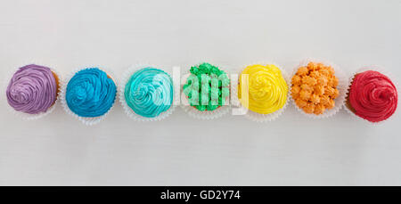 Regenbogen-Happy Birthday-Cupcakes auf dem weißen Hintergrund mit Textfreiraum Stockfoto