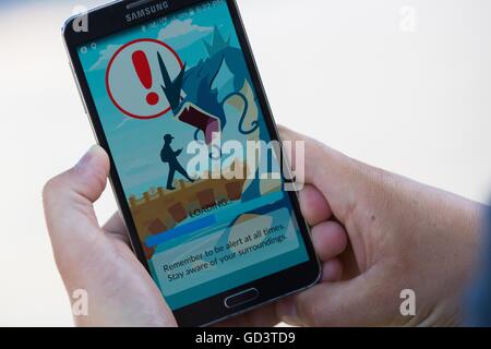 Kingston, Ontario, Kanada. 11. Juli 2016. Ein Mann spielt Pokemon gehen auf ein Samsung-Handy in Kingston, Ontario, am 11. Juli 2016. Bildnachweis: Lars Hagberg/ZUMA Draht/Alamy Live-Nachrichten Stockfoto