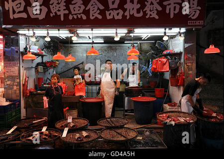 CHINA, Hongkong, 11. Oktober 2014. Fisch Anbieter warten Kunden an Ihrem Marktstand auf einem Wochenmarkt in Hongkong. Stockfoto