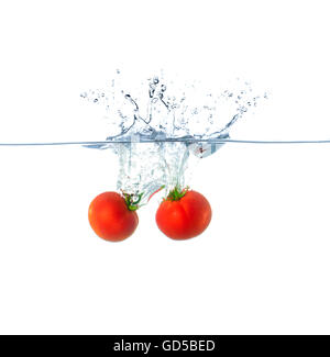 Rote Tomate planschen im Wasser, Isolated on White Background Stockfoto