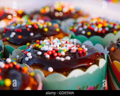 Muffins mit Schokolade und Bonbons bestreuen (Hunderte und Tausende) verziert Stockfoto