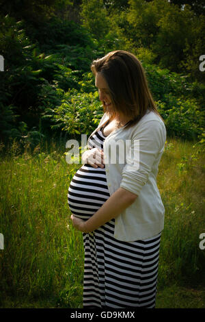 Eine werdende Mutter wiegt ihr ungeborenes baby Stockfoto