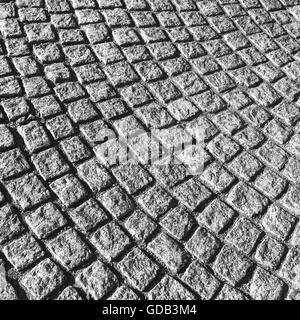 Dunkel graue Straße Kopfsteinpflaster mit runden Muster, urban Hintergrundtextur Stockfoto