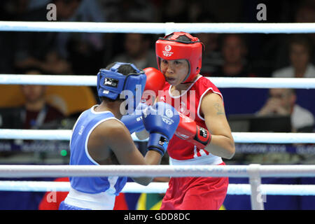 Laishram Devi von Indien (rot) konkurriert gegen Maria Machongua von Mosambik (blau) im Wettbewerb der Frauen Halbfinale geringes Gewicht Boxen (57-60kg) an die Commonwealth-Spiele 2014 in Glasgow. Laishram Devi von Indien ging auf gewinnen den Kampf. Stockfoto