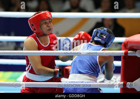 Laishram Devi von Indien (rot) konkurriert gegen Maria Machongua von Mosambik (blau) im Wettbewerb der Frauen Halbfinale geringes Gewicht Boxen (57-60kg) an die Commonwealth-Spiele 2014 in Glasgow. Laishram Devi von Indien ging auf gewinnen den Kampf. Stockfoto