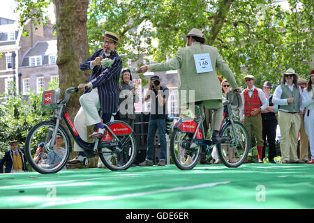 Bedford Square, London, UK. 16. Juli 2016. Der Chap-Olympiade - Teilnehmer in der Tee-Verfolgung. Die Beleuchtung der Olympischen Pipe. Hunderte von modisch gekleidete Teilnehmer und Zuschauer besuchen die Chap-Olympiade am Bedford Square in London feiern Großbritanniens sportliche Ungeschicklichkeit und Exzentrizität mit einer Reihe von Leichtathletik-Veranstaltungen, wo mehr Punkte für Stil, als erste über die Ziellinie vergeben werden. Bildnachweis: Dinendra Haria/Alamy Live-Nachrichten Stockfoto